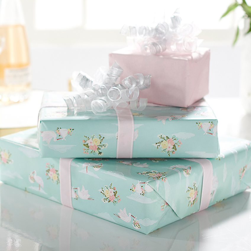 Stack of Gift Boxes Wrapped in White and Blue Floral Wrapping Paper